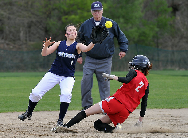 Allie Lemay of Westbrook covers second base as Kelsey Morton of South Portland slides in safely Friday during South Portland’s 10-0 victory at Westbrook. The Red Riots improved to 4-0 and dropped the Blue Blazes to 1-3.