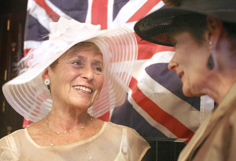 Merle Nelson of Falmouth, left, and Lennie Burke of Brunswick visit during a black tie formal party at the Cumberland Club in Portland on Friday to celebrate the royal wedding of William and Kate.