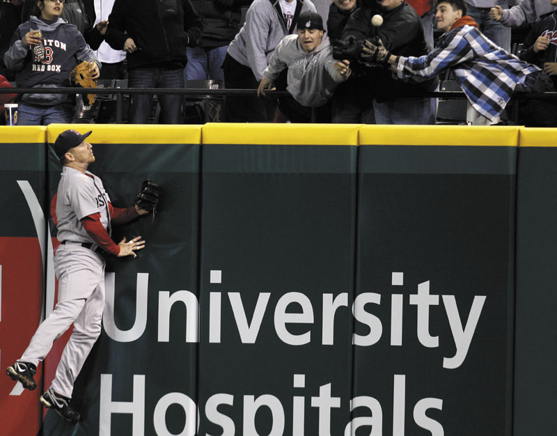 Boston Red Sox right fielder J.D. Drew jumps high but cannot reach a three-run home run hit by Cleveland Indians’ Asdrubal Cabrera in Wednesday’s game in Cleveland. It was the fifth in what has become a six-game losing streak. The winless Sox host the Yankees today in their home opener.