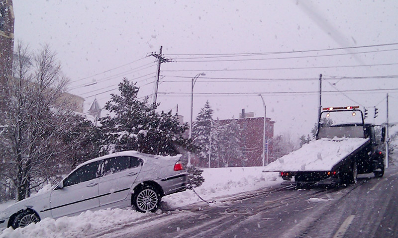 A tow truck pulls a car out of the snow on Franklin Arterial near Cumberland Avenue around 9:40 this morning. Photo taken by cellphone.