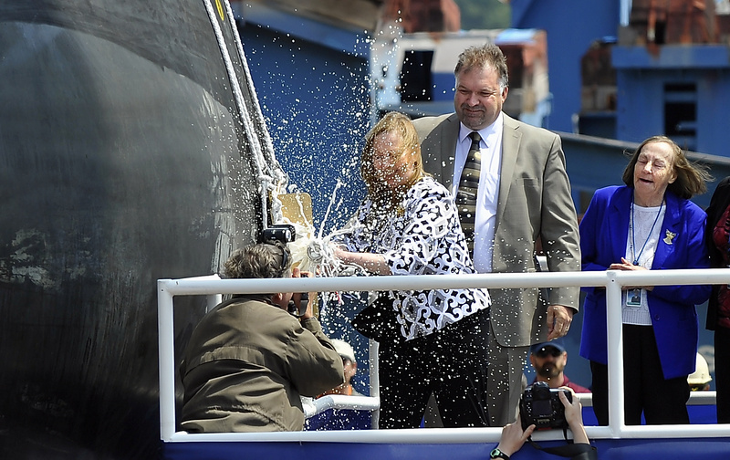 Maureen Murphy, Ship sponsor and mother of Michael Murphy, christens the Michael Murphy DDG 112 at Bath Iron Works with a bottle of champaigne today.