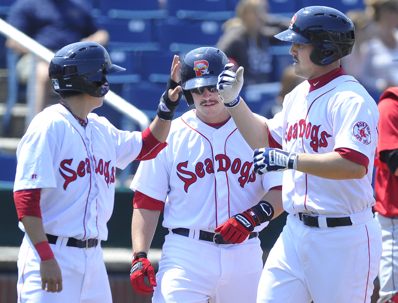 Ryan Lavarnway, right, gets congrats from teammates after his homer in Saturday's 15-7 win over the New Britain Rock Cats at Hadlock Field.