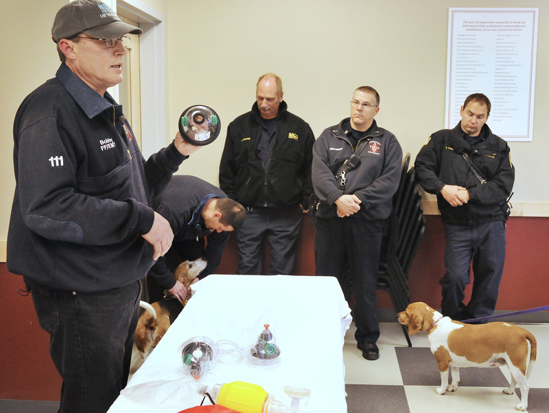 MAN’S BREATH FRIEND? – Bobby Silcott, an animal control officer in Naples, demonstrates the use of pet oxygen masks to members of the Saco and Biddeford fire and rescue departments this week. Silcott was able to donate six masks to each department thanks to a donation from Invisible Fence of Southern Maine and Seacoast New Hampshire. Silcott tried to demonstrate the use of the mask on his dog Elvis during the demonstration, but “Release Me” seemed to be the only tune on Elvis’ mind. With the oxygen masks, firefighters and rescuers can often save the life of a pet that has been removed from a burning building and may be suffering from smoke inhalation.