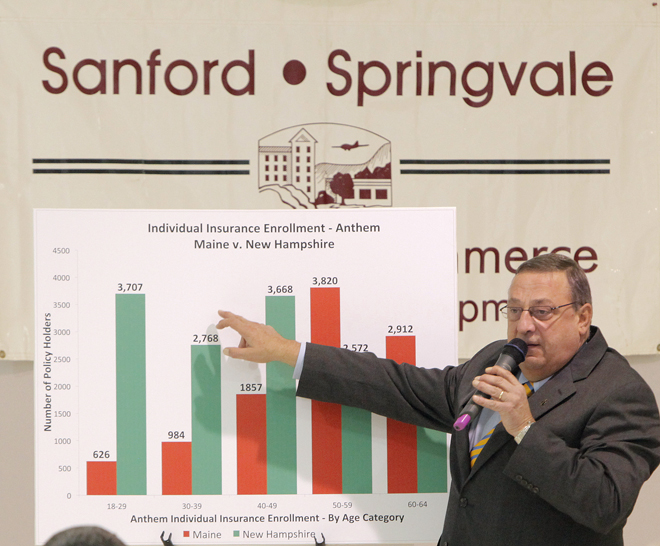 Gov. Paul LePage points out the differences between Maine and New Hampshire's rates of individual insurance enrollment through Anthem at the annual meeting of the Sanford-Springvale Chamber of Commerce and Economic Development in Sanford today.