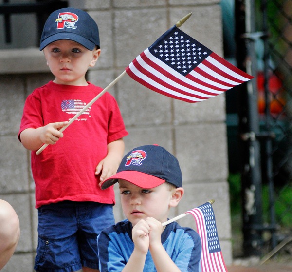 Reid Haile , 2, left, and Henry Haile 5, of Westbrook wave their flags as they watch veterans march along Congress St. During the Memorial Day Parade in Portland Monday, May 30, 2011.