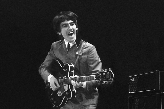 This Feb. 11, 1964, of George Harrison at the Washington Coliseum in Washington, D.C. The concert photos, taken when photographer Mike Mitchell was just 18 years old, will be auctioned by Christie's.