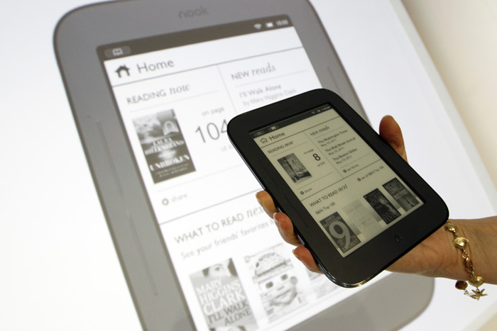 A product specialist holds up a new Nook during a news conference today in New York. The new Nook features a black-and-white touch screen and aims squarely at the "grandma" demographic.