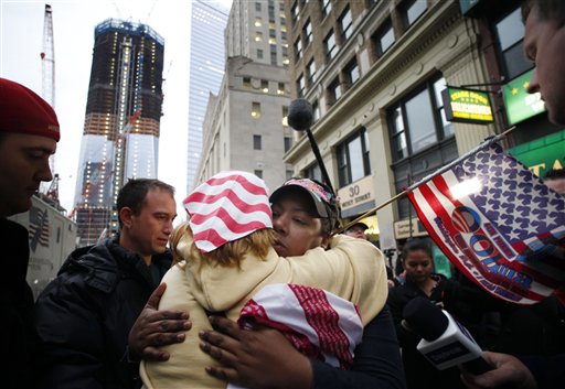 Dionne Layne, facing camera, hugs Mary Power as they react to the news of the death of Osama bin Laden today in New York. At left is the rising tower, 1 World Trade Center, also known as the Freedom Tower.