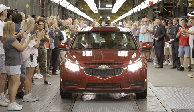 General Motors workers cheer as the first Chevrolet Cruze compact sedan rolls off the assembly line at the GM factory in Lordstown, Ohio, in 2010.