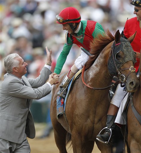 Trainer Todd Pletcher, left, congratulates John Velazquez after Velazquez rode Animal Kingdom to victory during the 137th Kentucky Derby horse race at Churchill Downs Saturday.