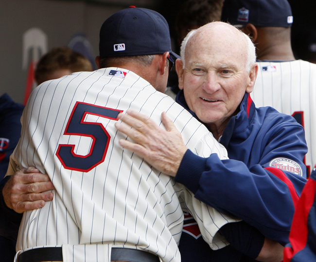 In this April 12, 2010, photo former Minnesota Twins baseball great Harmon Killebrew gets a hug from current Twins player Michael Cuddyer in the dugout prior to a Twins' game against the Boston Red Sox in Minneapolis.