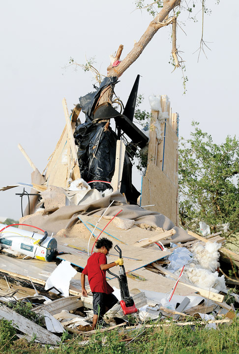 Harley Voyager removes a vacuum cleaner from the tornado-ravaged home of Jeremy and Crystal Sullins on Tuesday after the new double-wide trailer was destroyed by an apparent tornado northwest of Longdale, Oklahoma. The Sullinses were not injured. HARLEY VOYAGER OKLAHOMA TORNADO JEREMY AND CRYSTAL SULLINS