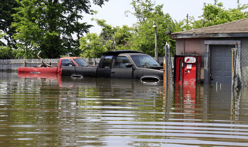 Floodwater surrounds two pickup trucks outside a garage in Memphis, Tenn.