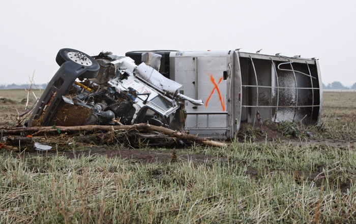 A truck lies in a field following a tornado in Piedmont, Okla. The "x" indicates that the vehicle has been checked for survivors.