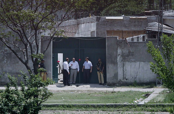 Pakistani security officials leave after the examining the house today where al-Qaida leader Osama bin Laden was killed in Abbottabad, Pakistan.