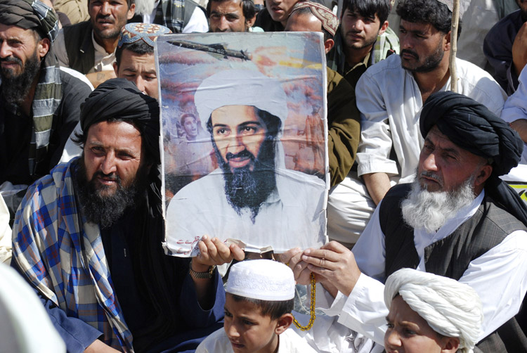 Supporters of Pakistani religious party Jamiat Ulema-e-Islam hold al-Qaida leader Osama bin Laden's picture during a rally in Kuchlak, Pakistan, today.