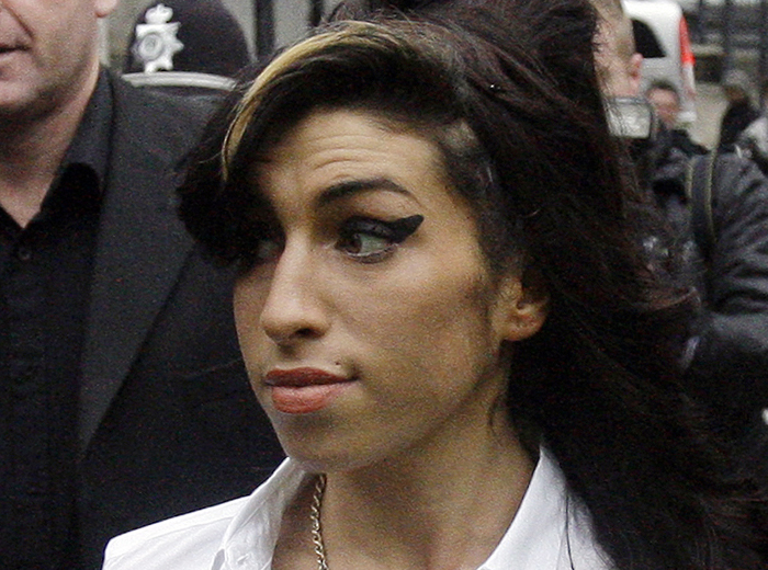 In this 2010 photo, British singer Amy Winehouse arrives at Magistrates Court in Milton Keynes, England.