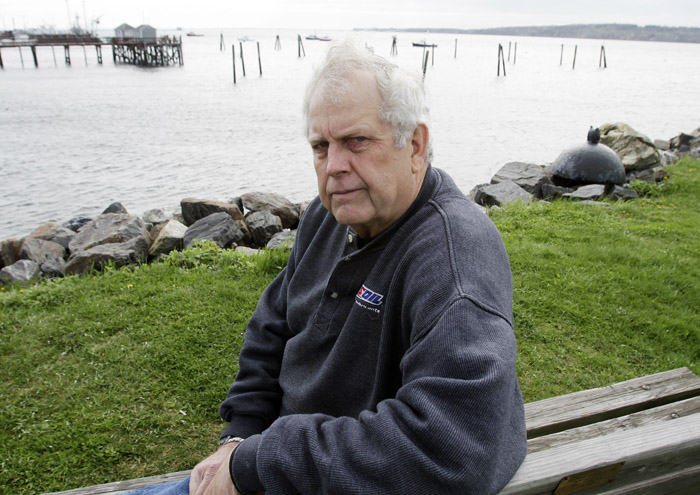 Author and former Navy underwater photographer Steve Waterman sits on the waterfront in Rockland, Maine, recently. Waterman says it's easy to ferret out the real Navy SEALs from the phonies. Dead giveaways are loose tongues and bravado.