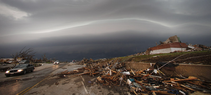 A shelf cloud containing a thunderstorm approaches a tornado-ravaged neighborhood in Joplin, Mo., today, where a large tornado moved through much of the city Sunday, damaging a hospital, hundreds of homes and businesses and killing at least 89 people.