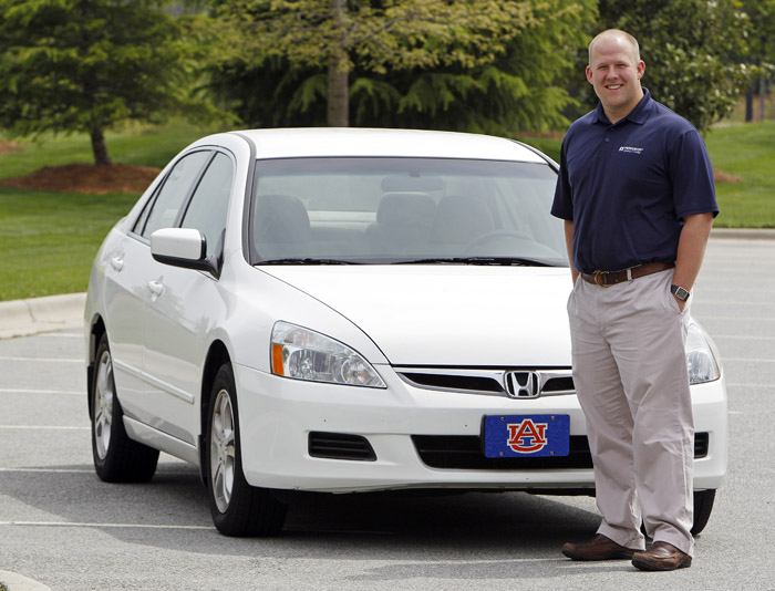 Jeremy Barnes poses recently in front of the 2007 Honda he is selling near his home in Greensboro, N.C. With used-car prices at 16-year highs, and a child on the way for him and his wife, Barnes is hoping to sell it for a good price and most likely spend more on the new car they buy.