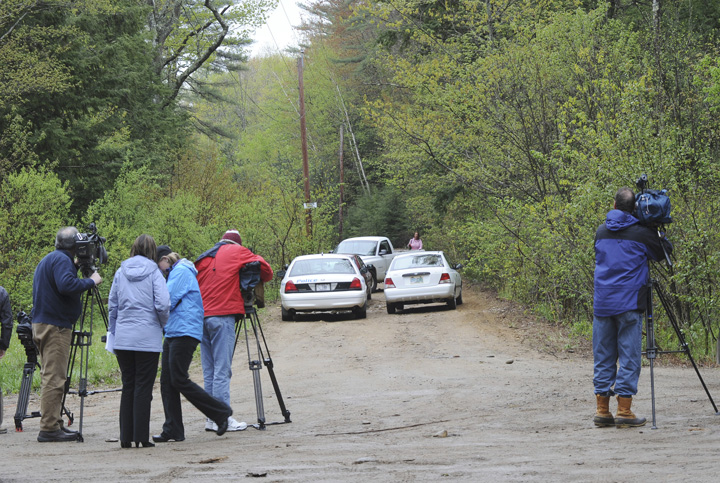 News media gather at the site where the body of a young boy was found off this dirt road, at 100 Dennett Road in South Berwick on Saturday.