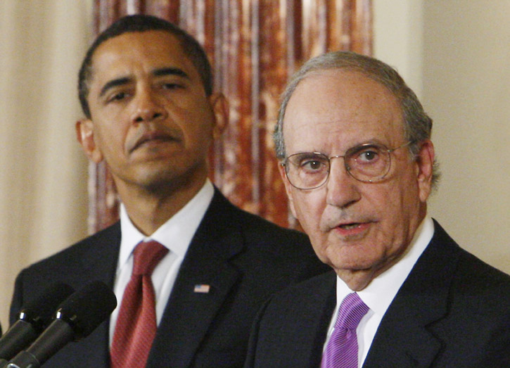 With President Barack Obama looking on, Middle East envoy George Mitchell speaks at the State Department in Washington in this Jan. 22, 2009, photo.