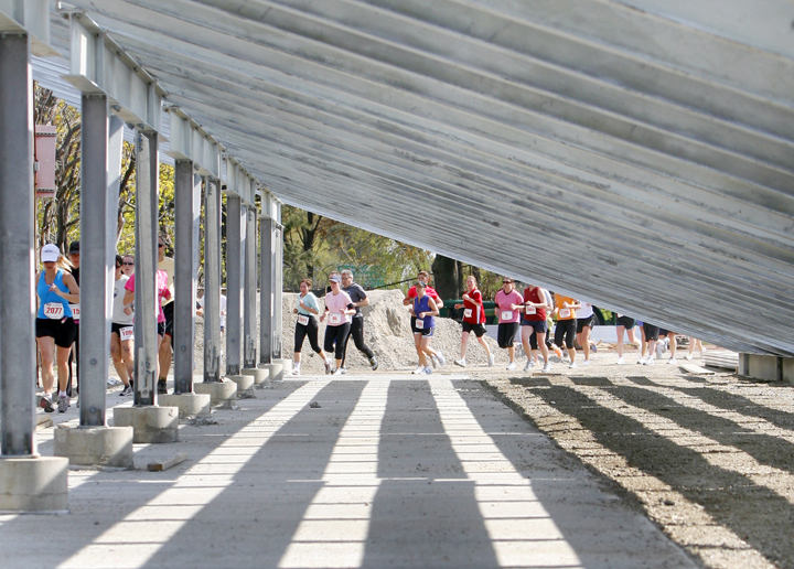 Runners pass the bleachers at Fitzpatrick Stadium during the Mothers' Day 5K.