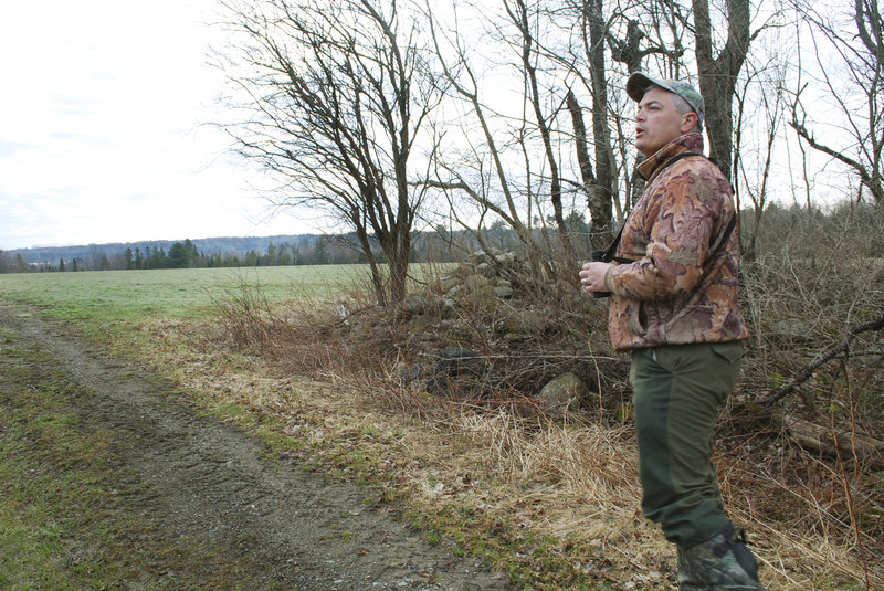 Joe Saltalamachia scouts for turkeys last week in Unity, where he’s gotten permission to hunt on farmland when the spring season begins Monday. Waldo and Knox counties, with their mix of open farm fields and woods, have become popular areas for turkey hunters.