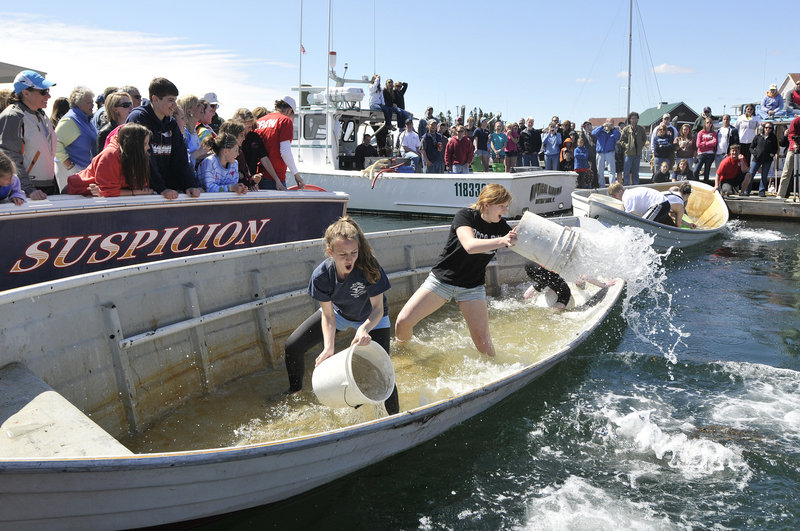 Mia DeGroote, left, of Boothbay and Katie Burns of Cumberland give it their best in the dory bailing competition.