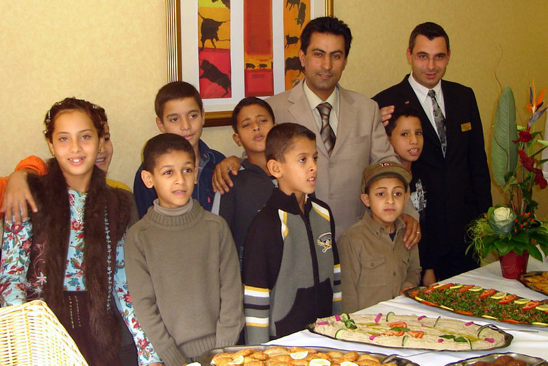 In this undated photo, Dr. Jebril Elabidi, center, poses in Montpellier, France, with some of the 400 or so children infected with HIV in a 1998 outbreak in a Benghazi, Libya, hospital. The pediatrician blames six foreign caregivers, not poor hospital hygiene, for the outbreak.