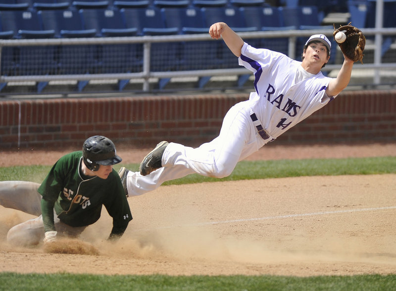 Jared Bell of Deering leaps to haul in an errant throw Saturday as Matt Burnell of Bonny Eagle slides safely into third base during their Telegram League game at Hadlock Field. Deering earned an 8-4 victory.