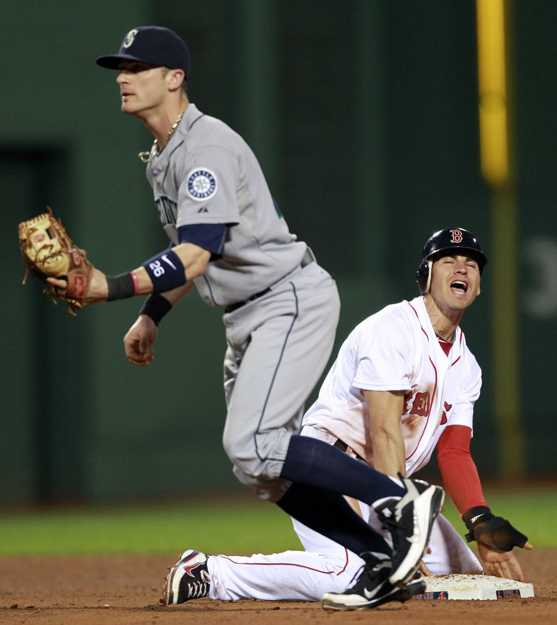 Seattle’s Jack Wilson, left, forces out Jacoby Ellsbury at second base after a line drive by Boston’s Adrian Gonzalez in the fifth inning Saturday night at Fenway Park. Seattle won 2-0, handing Boston its fourth loss in five games.