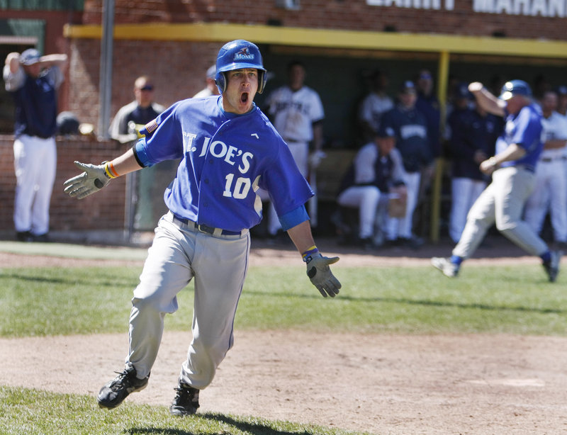 Pinch hitter Dan Brown, who earlier in the game sold raffle tickets in the stands, celebrates his game-winning RBI double in the ninth inning as the Monks rallied to beat Suffolk 8-6 to win the GNAC title and earn a berth in the NCAA Division III tournament.