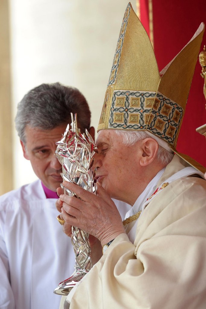 Pope Benedict XVI kisses the glass reliquary containing the blood of the late Pope John Paul II during his beatification ceremony at the Vatican on Sunday. To be declared a saint, John Paul II needs another miracle attributed to his intercession.
