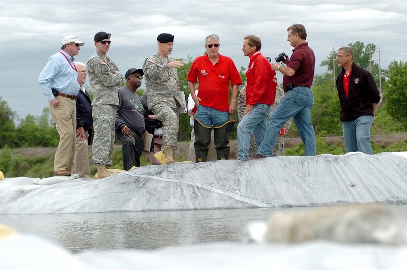 Maj. Gen. Michael Walsh gestures while being briefed by Army Corps of Engineers personnel during a stop in Cairo, Ill., on Saturday. Walsh said that the Mississippi River levee system is under more pressure now that it has been since it was built in 1928.