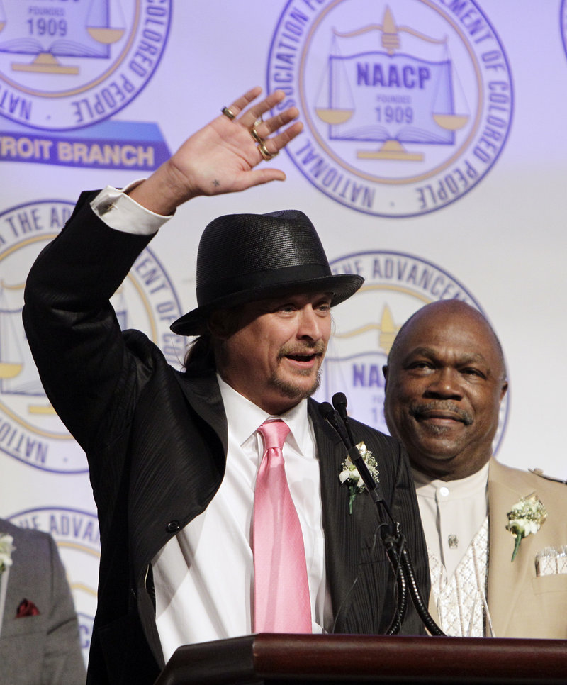 Kid Rock, standing next to NAACP Detroit Chapter President Wendell Anthony, acknowledges the audience during the organization’s annual fundraising dinner in Detroit on Sunday.