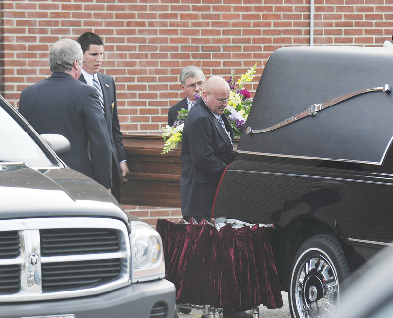 Krista Dittmeyer's casket is carried to a hearse after a service in the Lake Region High School gymnasium Monday afternoon. Her body was found last week in a pond at Cranmore Mountain Resort ski area in North Conway, N.H.