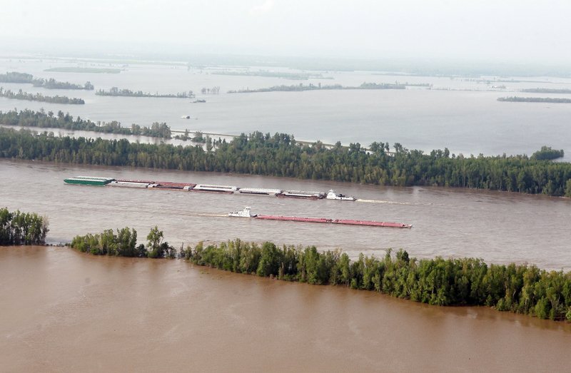 Barge traffic moves along the Mississippi River near Cairo, Ill., last week. Maj. Gen. Michael Walsh, who commands the Mississippi Valley division of the Army Corps of Engineers, decided Monday that the best course to relieve pressure on the flood wall at Cairo was to blow a massive hole in the Birds Point floodway levee in southeast Missouri.