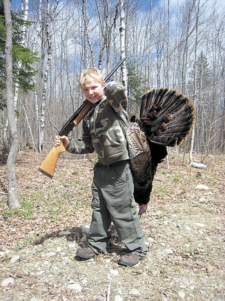Brad Clark carries the tom turkey he shot on youth hunting day, Saturday. He said it was “pretty exciting.”