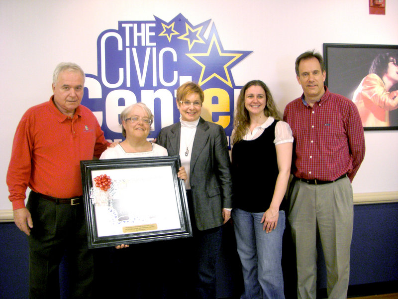 Brenda S., second from left, an artist and consumer at Port Resources, presented her painting, “the bridge,” to officials at the Cumberland County Civic Center for its support in providing consumers with tickets to events at the civic center. From left, Steve Crane, general manager of the civic center, Brenda S., Roberta Wright, event services director at the civic center, and Kimberly Hubbard and Eric Knutsen of Port Resources