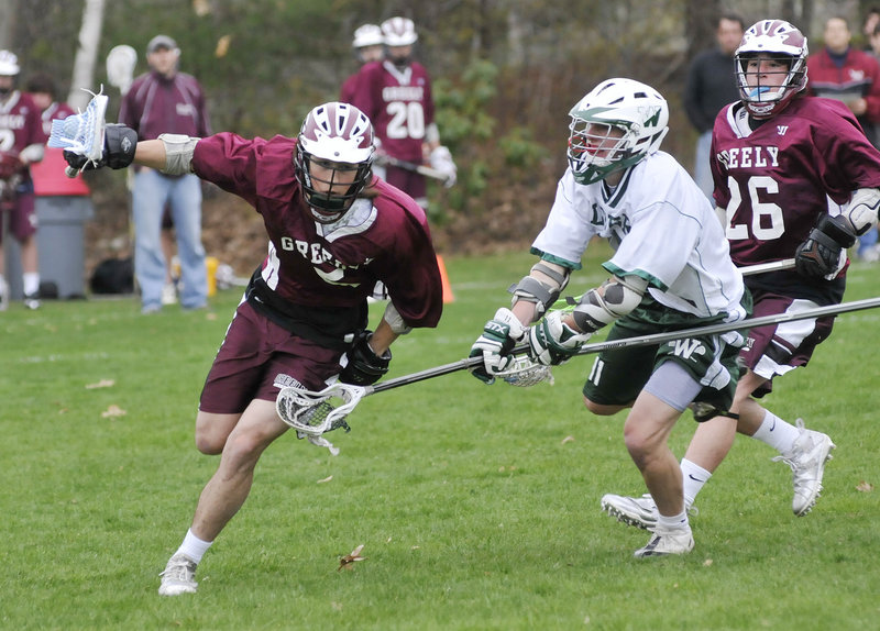 Jake Eustis of Greely, left, controls the ball Tuesday as Will Cleaves of Waynflete attempts to knock it away during their schoolboy lacrosse game Tuesday. Waynflete came away with a 9-8 victory in Portland.