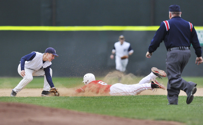 Paul Reny of South Portland gets his hand onto second base ahead of a tag by Portland shortstop Tim Rovnak to earn a stolen base in the first inning of their Telegram League game Tuesday at Hadlock Field. South Portland won, 7-0.