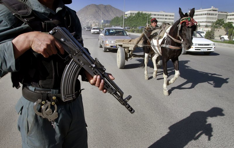 An Afghan police officer stands guard at a check point in Kabul Tuesday. The killing of Osama bin Laden is seen as creating an “opportunity for reconciliation that didn’t exist before,” one official says, meaning a more palatable outcome for Americans and insulating Obama from criticism his administration would negotiate with terrorists.
