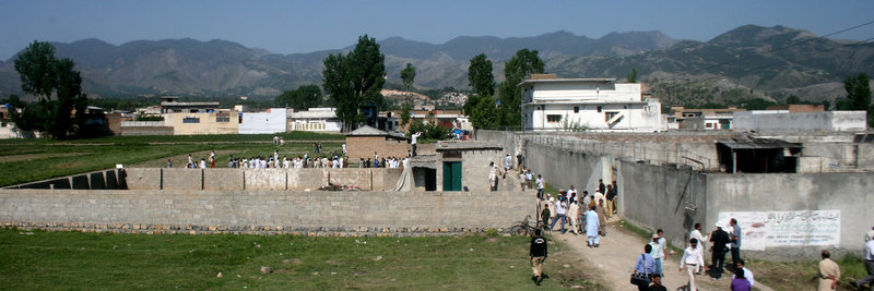 Local residents and news media gather Tuesday at the compound and house, on right, of Osama bin Laden after authorities allowed people to approach the perimeter of the property in Abbottabad, Pakistan. White House counterterrorism adviser John Brennan said the U.S. already was scouring through items seized in the raid, including computers, DVDs and documents. There was “more than we were expecting to find,” said a U.S. intelligence official who insisted on not being named. “There’s written material, pictures – there’s all kinds of stuff.”
