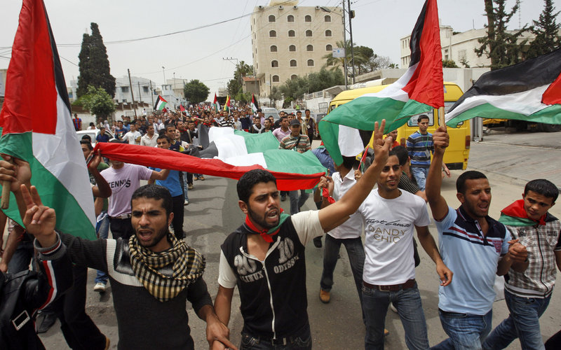 Palestinians celebrate a reconciliation agreement between Fatah and Hamas in Gaza City Wednesday. The accord would end a four-year rift between the bitter rivals and pave the way for a joint caretaker government.
