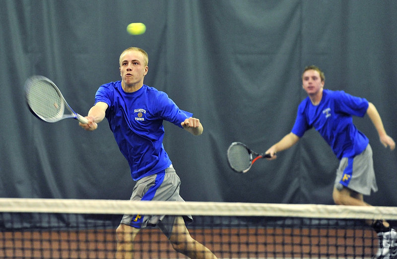 Connor Burfeind of Falmouth returns a shot as his doubles partner, Tom Wilberg, backs him up during a three-set victory.
