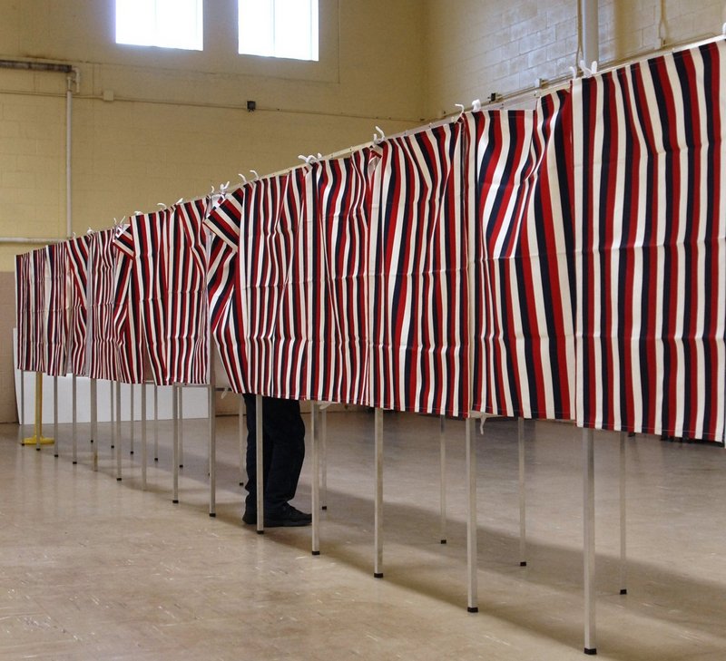 A lone voter fills out a ballot in Westbrook, a community said to be in an overpopulated Maine Senate district.