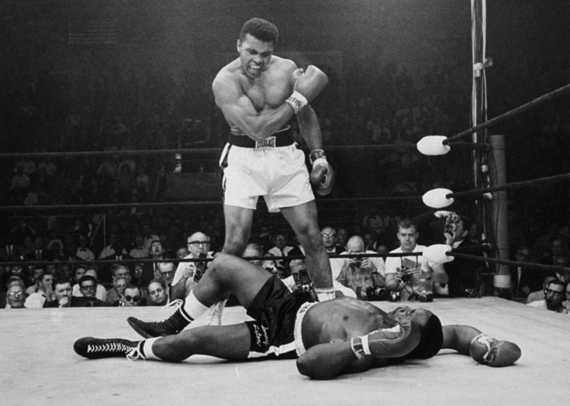 Heavyweight champion Muhammad Ali stands defiantly over fallen challenger Sonny Liston shortly after dropping him with a right hand to the jaw during their historic fight in Lewiston on May 25, 1965. The bout lasted only 1 minute into the first round. Ali is the only man ever to win the world heavyweight championship three times.