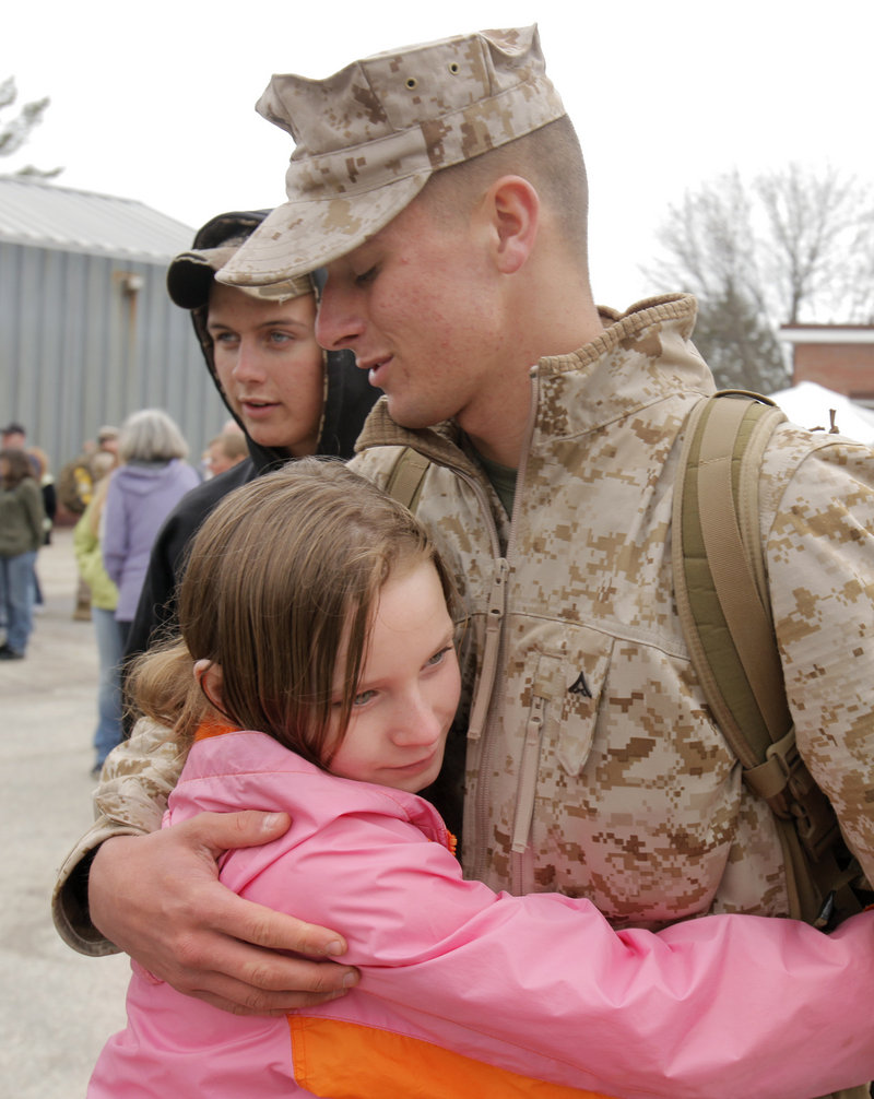 Lance Cpl. Tim Carter, 18, of Machias gets a hug from his11-year-old sister, Libby, before boarding a bus Thursday at the Marine Corps Reserve Training Center in Topsham.