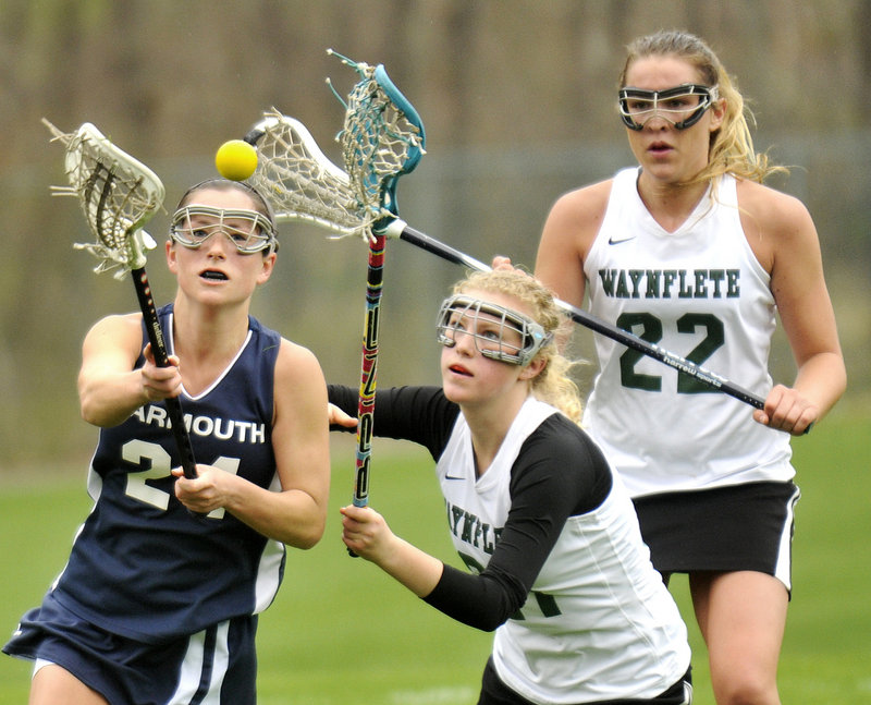Danielle Torres of Yarmouth, left, and Lucy Crane of Waynflete compete for a loose ball Thursday during Waynflete's 11-10 victory at home. Moving in for the Flyers is Scout Haffenreffer. Waynflete improved to 3-1. Yarmouth is 3-1.